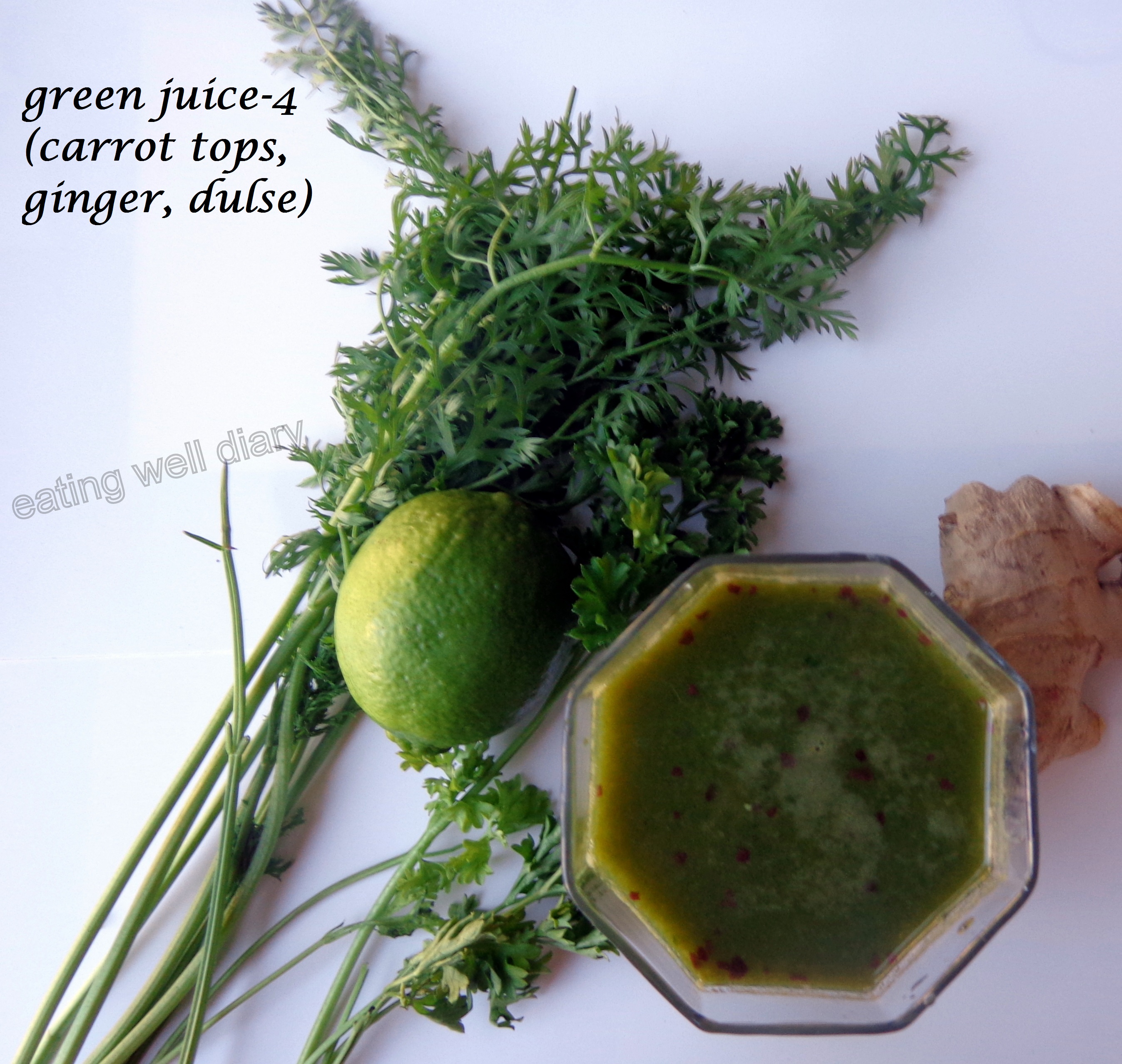 Green juice with carrot tops, ginger and dulse flakes