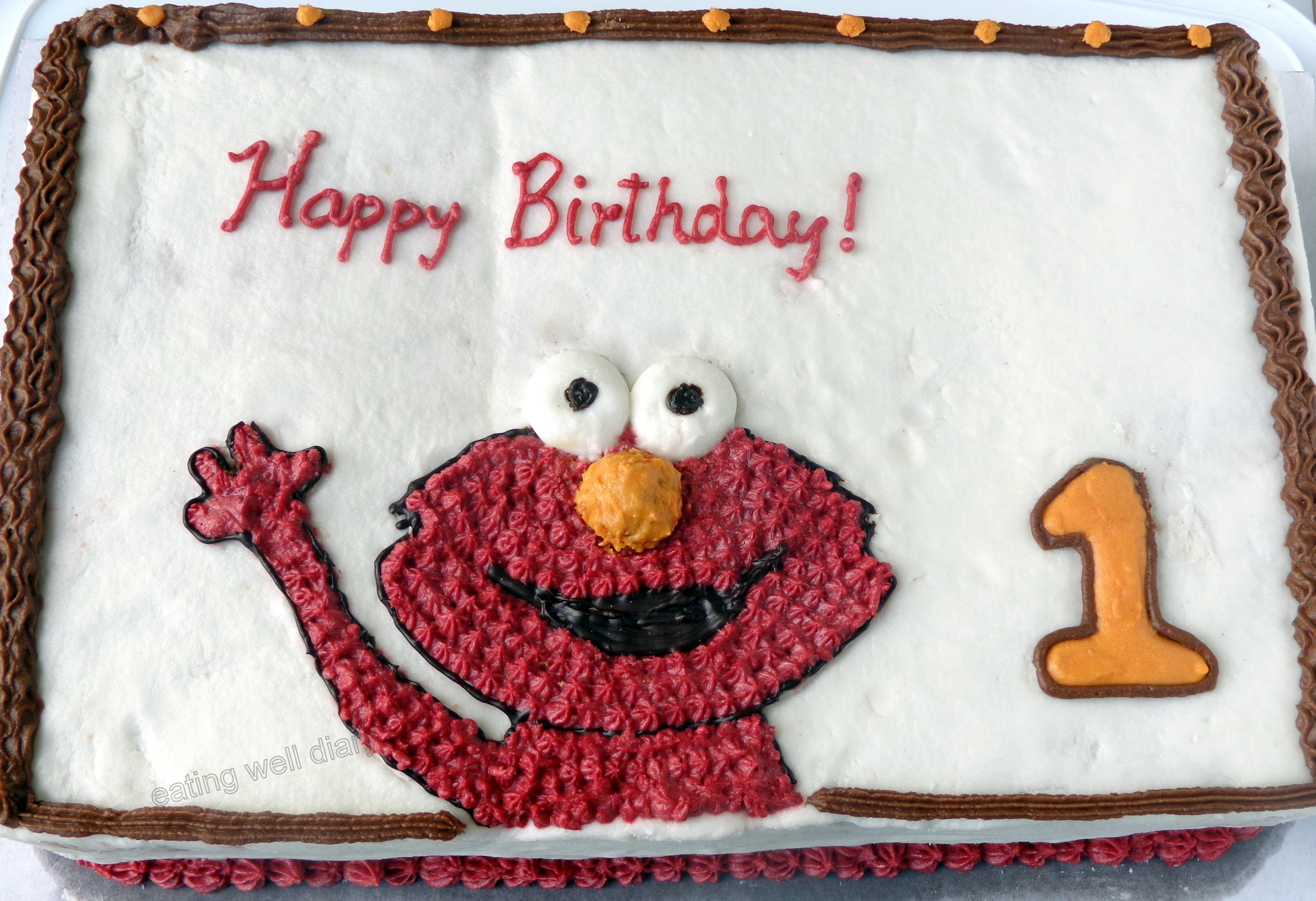 An Elmo themed vanilla birthday cake (whole wheat, eggless, natural colors)